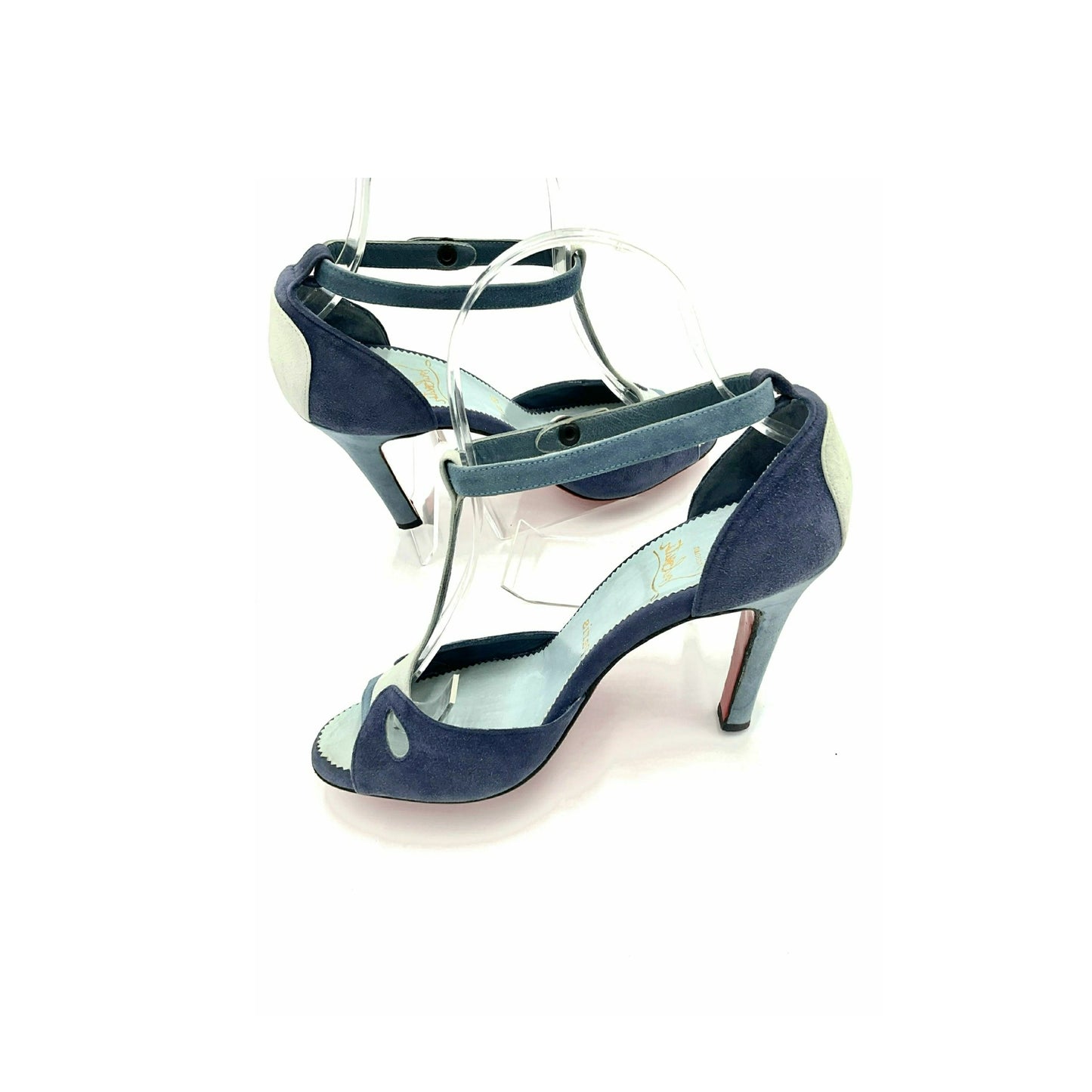 Louboutin high heels, featuring a suede texture and a gradient of light to dark blue, with the brand's distinctive red sole