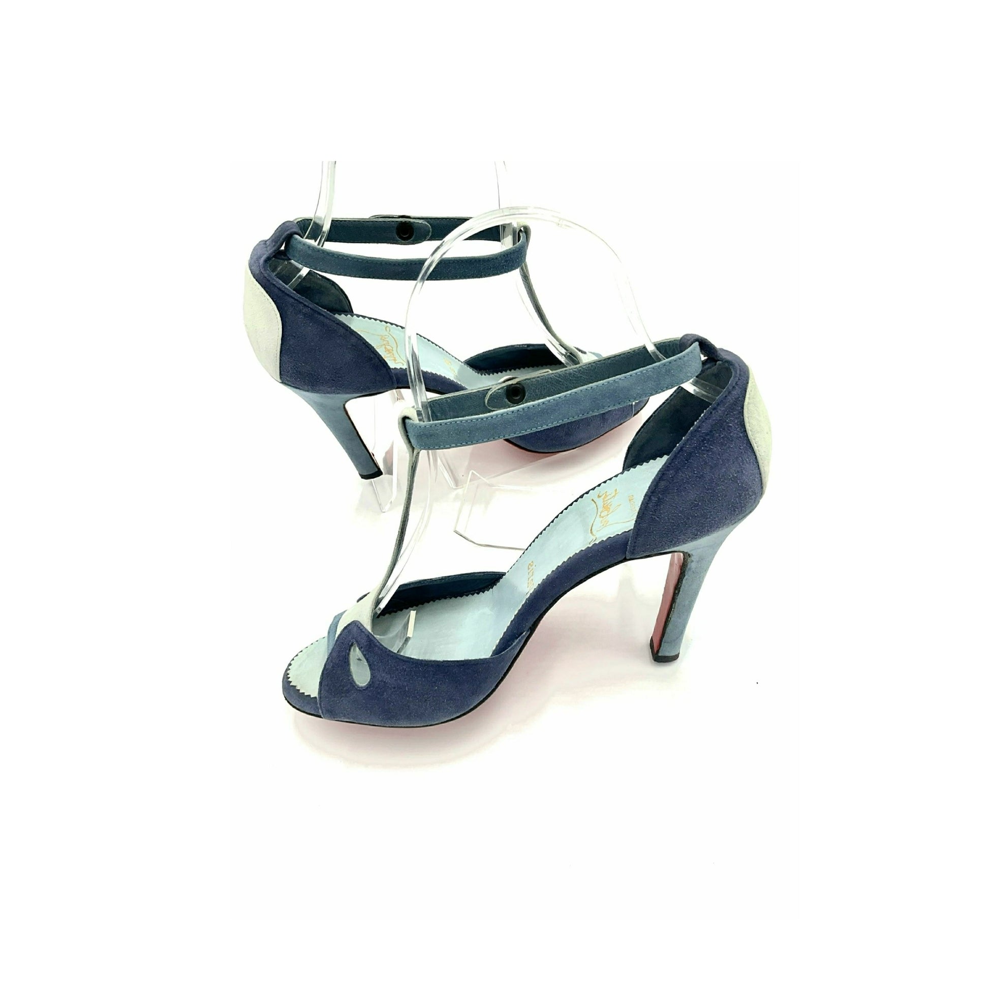 Louboutin high heels, featuring a suede texture and a gradient of light to dark blue, with the brand's distinctive red sole