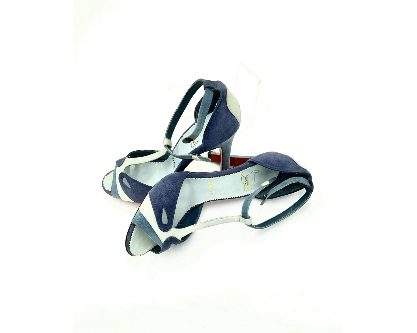 Louboutin high heels, featuring a suede texture and a gradient of light to dark blue, with the brand's distinctive red sole