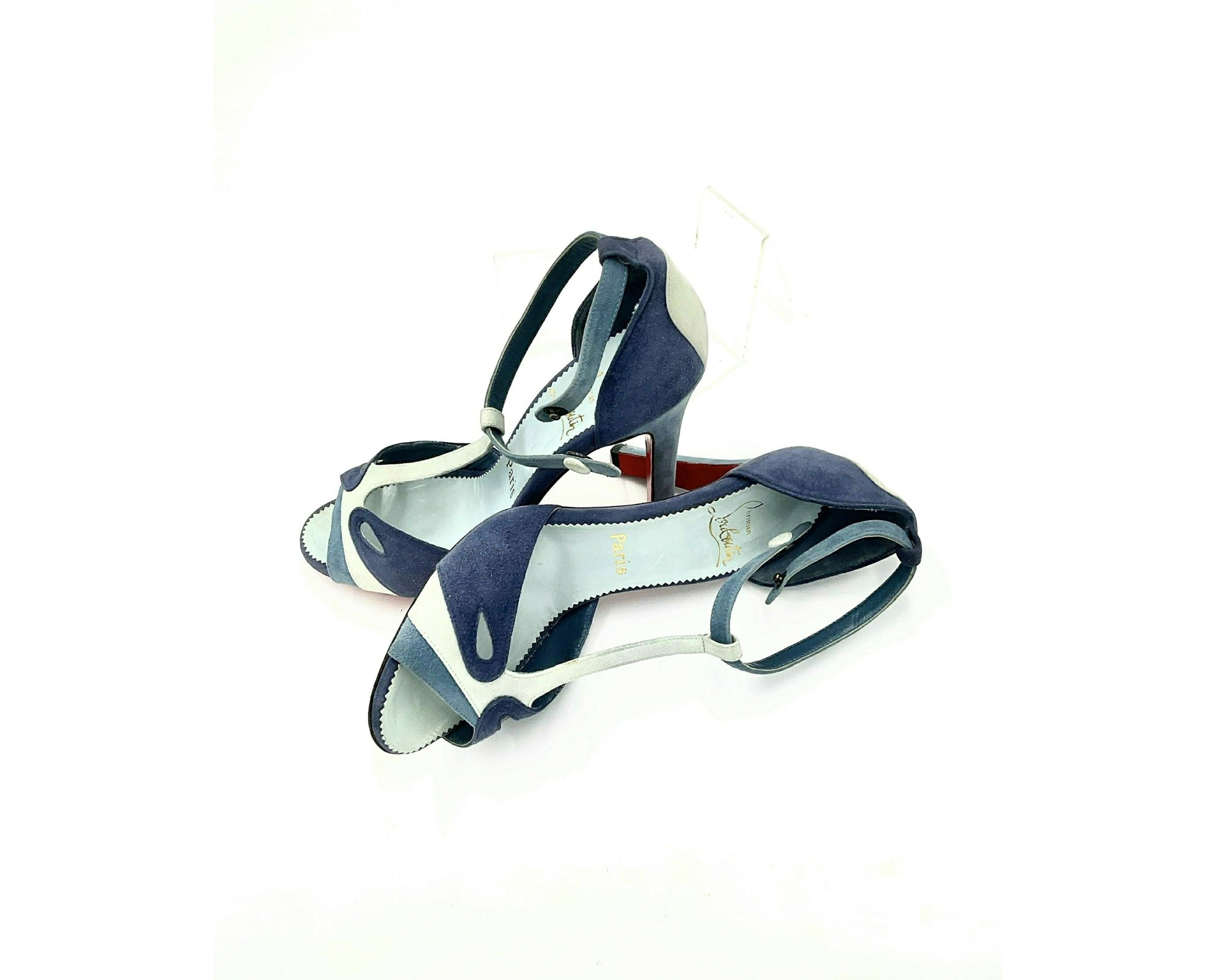 Louboutin high heels, featuring a suede texture and a gradient of light to dark blue, with the brand's distinctive red sole