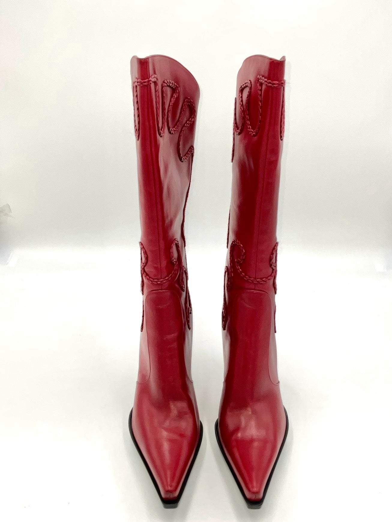 Pair of red high-heeled boots on a white background