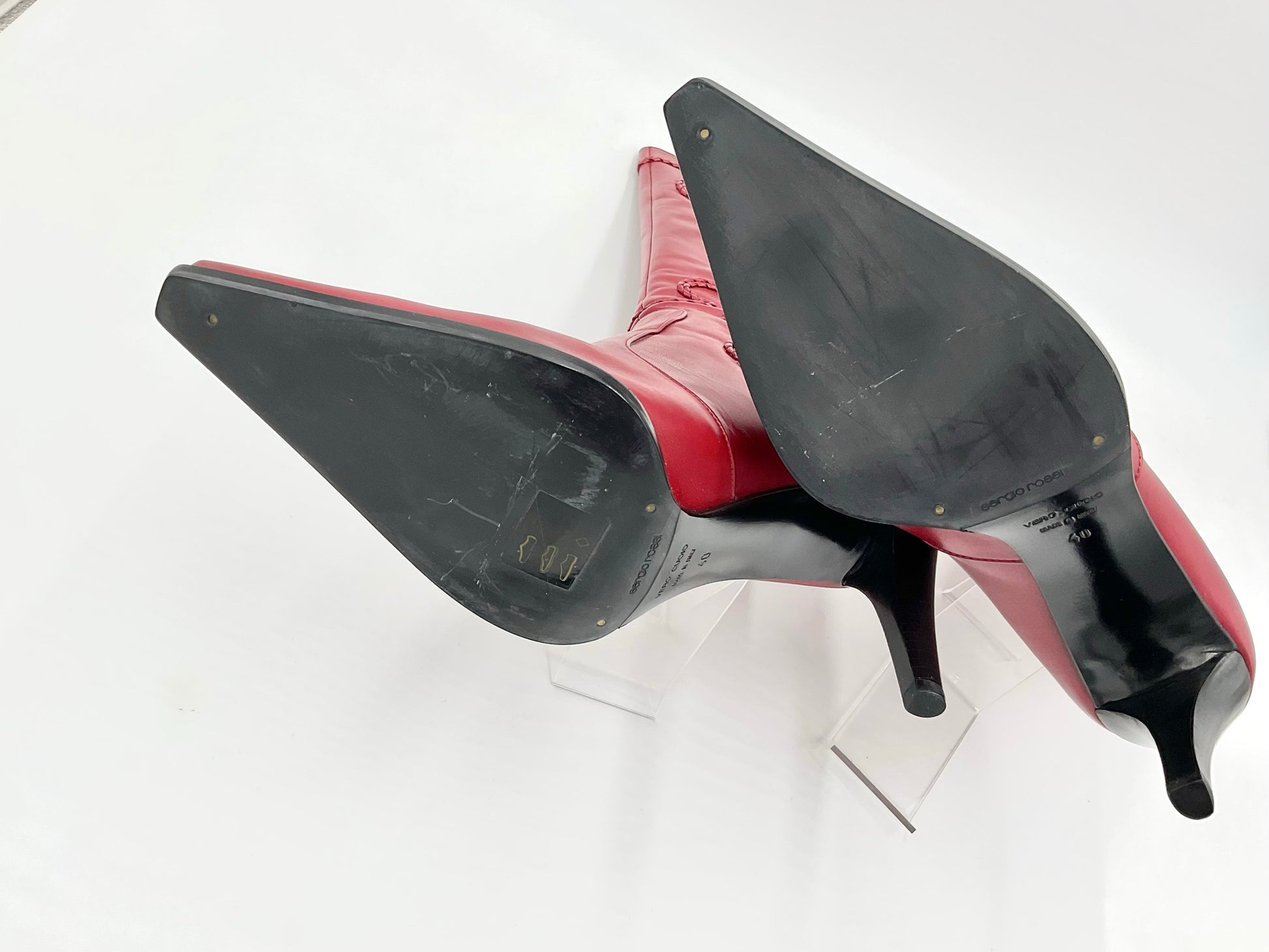 Red high-heeled shoes with black soles on a white background