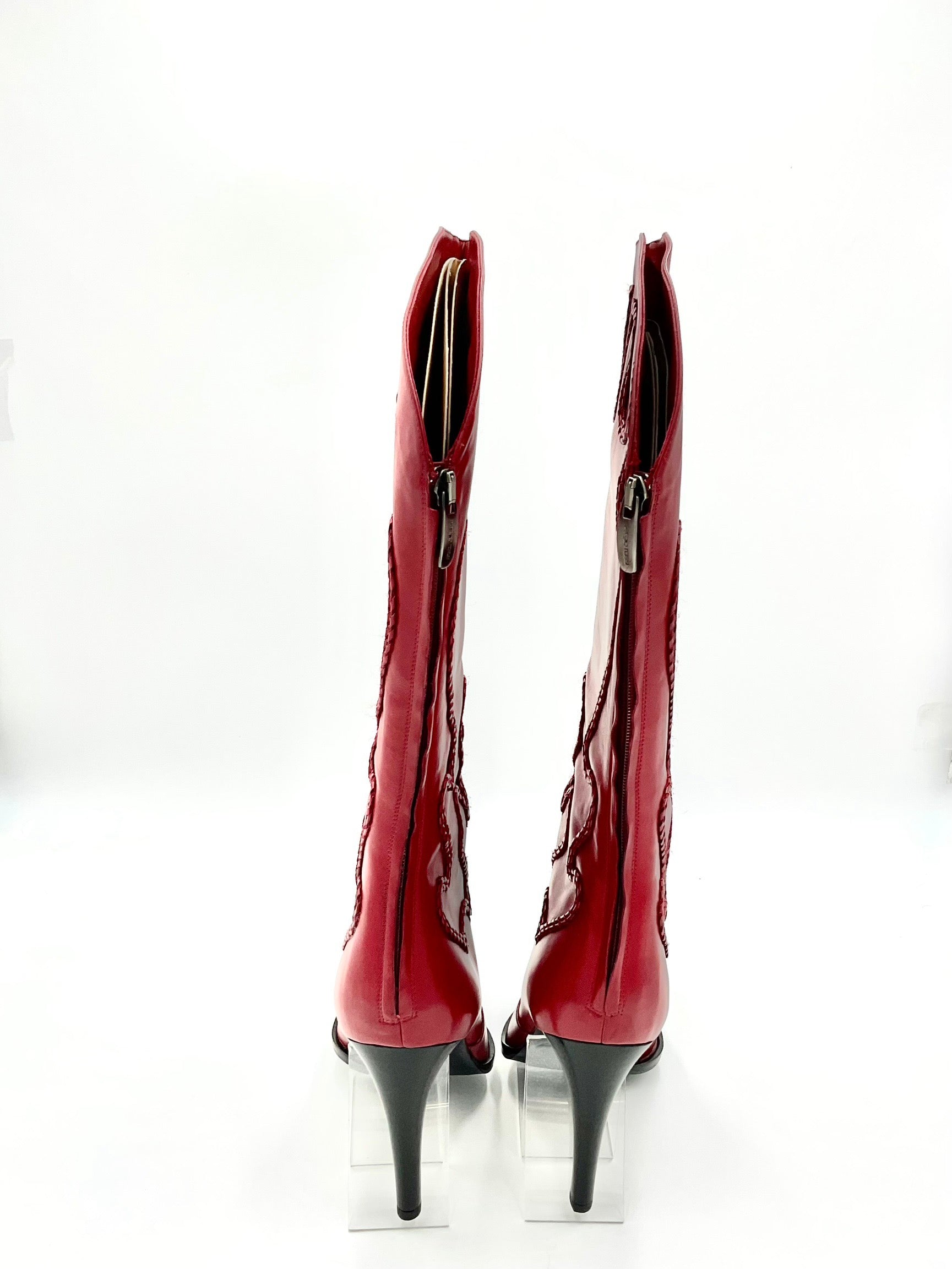 Pair of red high-heeled boots on a white background