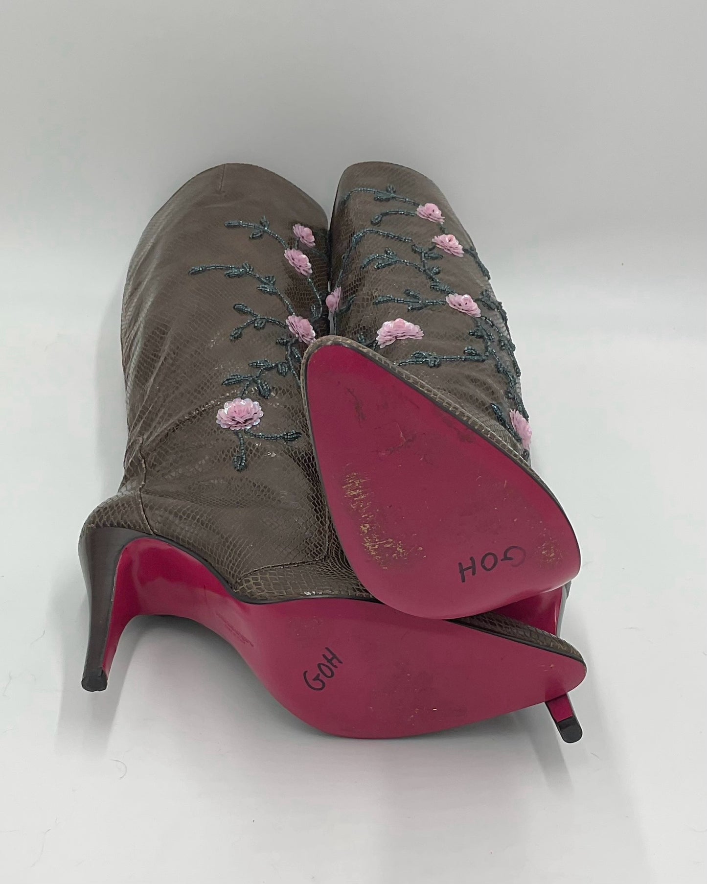 Brown boots knee-high lizard skin print adorned with intricate sequins and floral details.