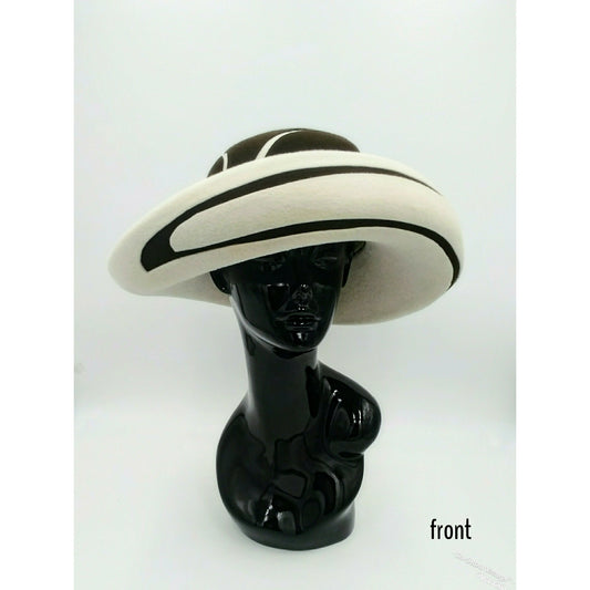 Black mannequin head with a cream and Chocolate brown striped hat on  cream with a Chocolate brown background