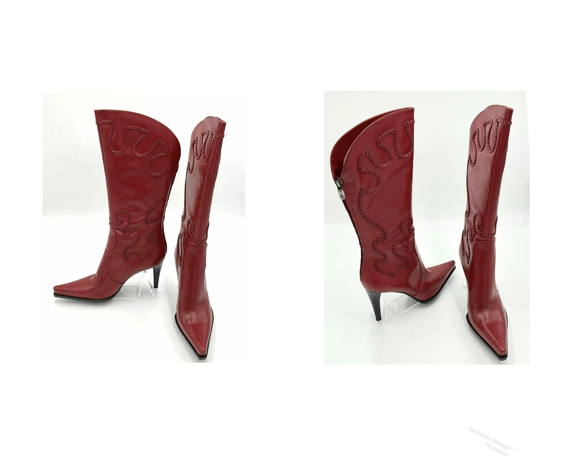 Red cowboy boots with intricate designs on a white background