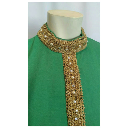 Green dress, highlighing the top portion to show the gold trim and imitation pearls and rhinestones of the neckline on a mannequin against a white background