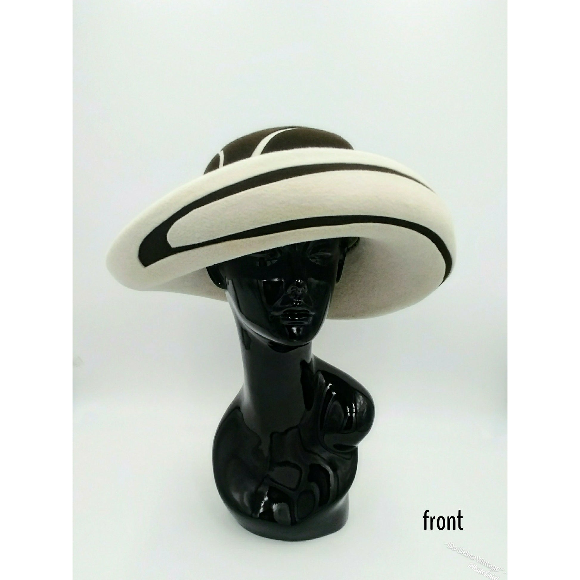 Black mannequin head with a cream and Chocolate brown striped hat on  cream with a Chocolate brown background