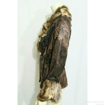 A vintage brown patterned jacket with a brown and beige fur collar and hem, displayed on a cream mannequin torso against a white background.