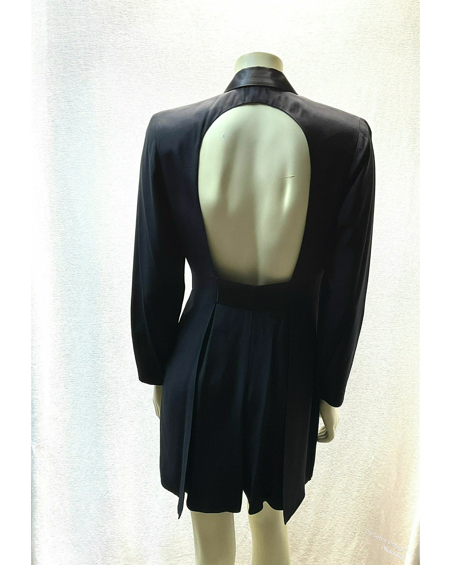 A black long sleeve Skort displayed on a mannequin from the back, featuring a large open back cutout and showing the back of skort.