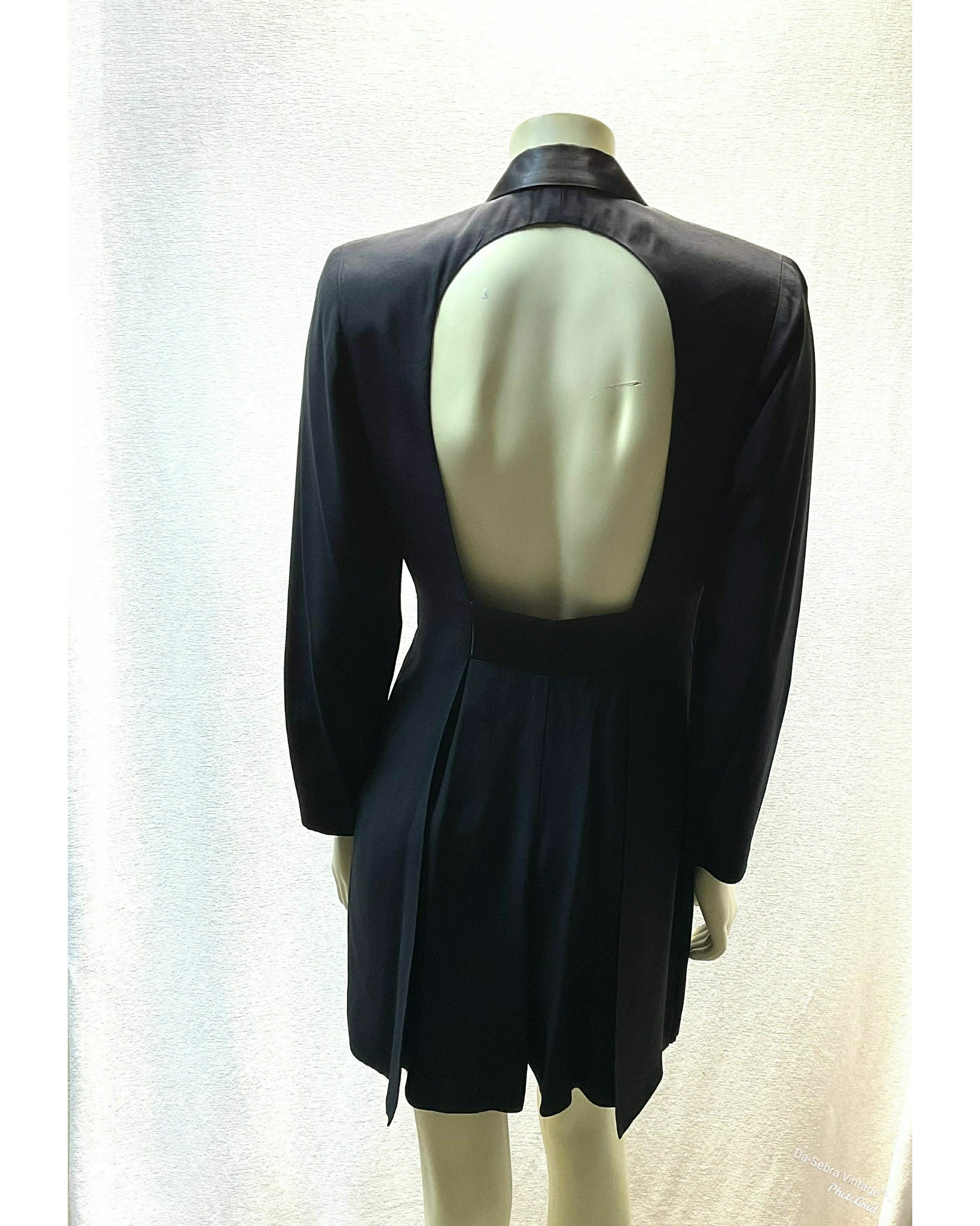 A black long sleeve Skort displayed on a mannequin from the back, featuring a large open back cutout and showing the back of skort.