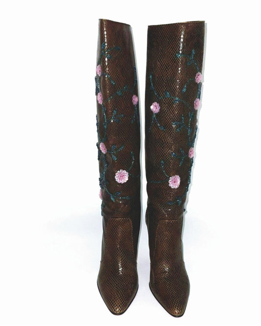 Brown  boots knee-high lizard skin print adorned with intricate sequins and floral details.  