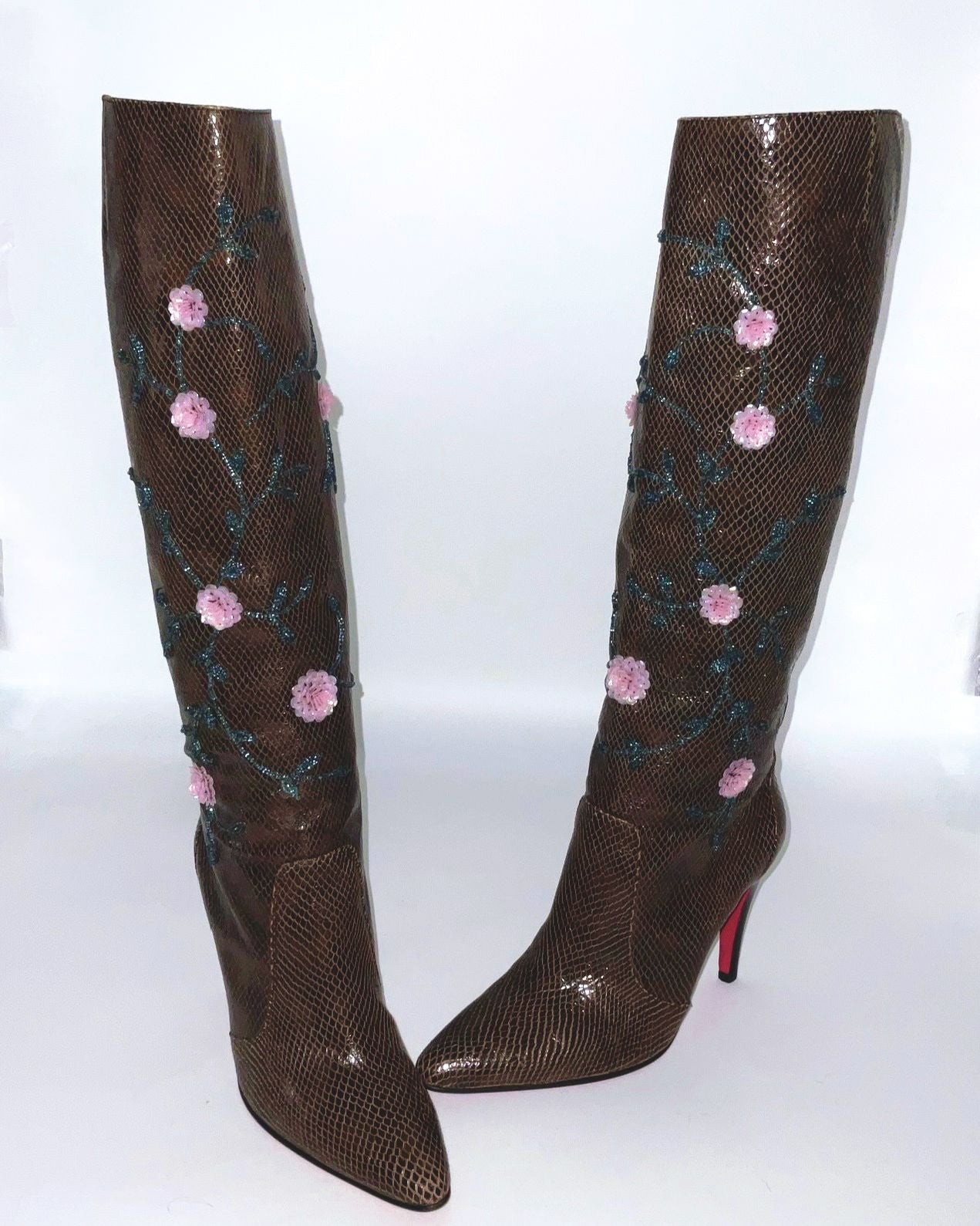 Brown  boots knee-high lizard skin print adorned with intricate sequins and floral details.  
