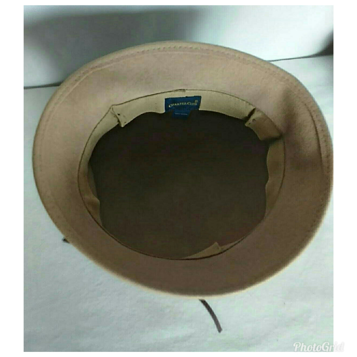 A beige wide-brim hat viewed from the inside, showing the inner crown lining and a small blue brand tag that reads 'Charter Club'