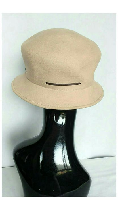 Back view of beige felt bucket hat with a dark brown horizontal band detail, displayed on a glossy black mannequin head against a white background.