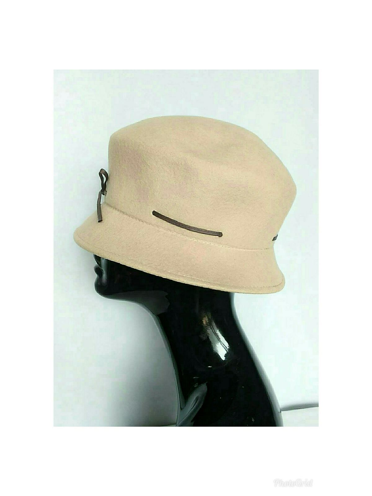 Left view of a Camel color felt cloche hat with dark brown decorative trim, displayed on a black mannequin head against a white background.
